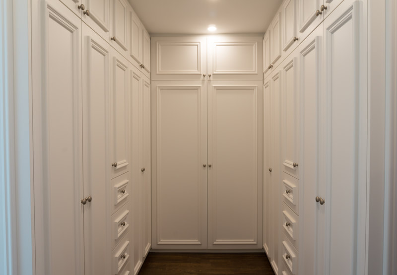 Walk-In closet with applied mouldings on cabinet doors